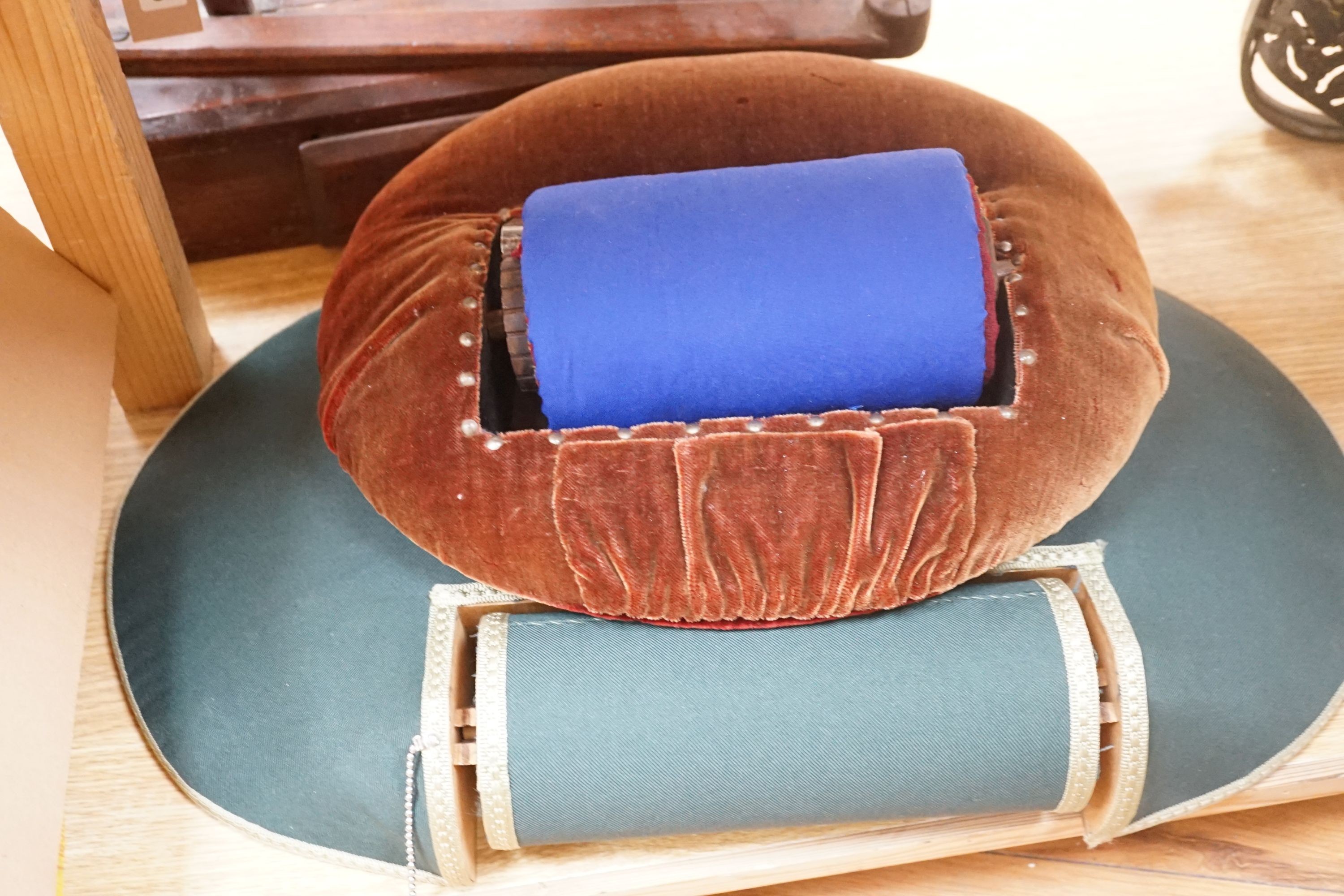 An antique lacemaker's pillow and a modern lacemaker's pillow and a lacemaker's bobbin winder